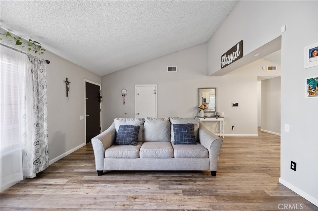 638 Eston Place Lancaster, CA 93535 - Photo 9 of 44 a living room with furniture and a wooden floor