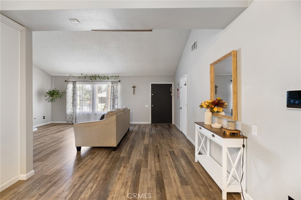 638 Eston Place Lancaster, CA 93535 - Photo 10 of 44 a living room with furniture and a wooden floor