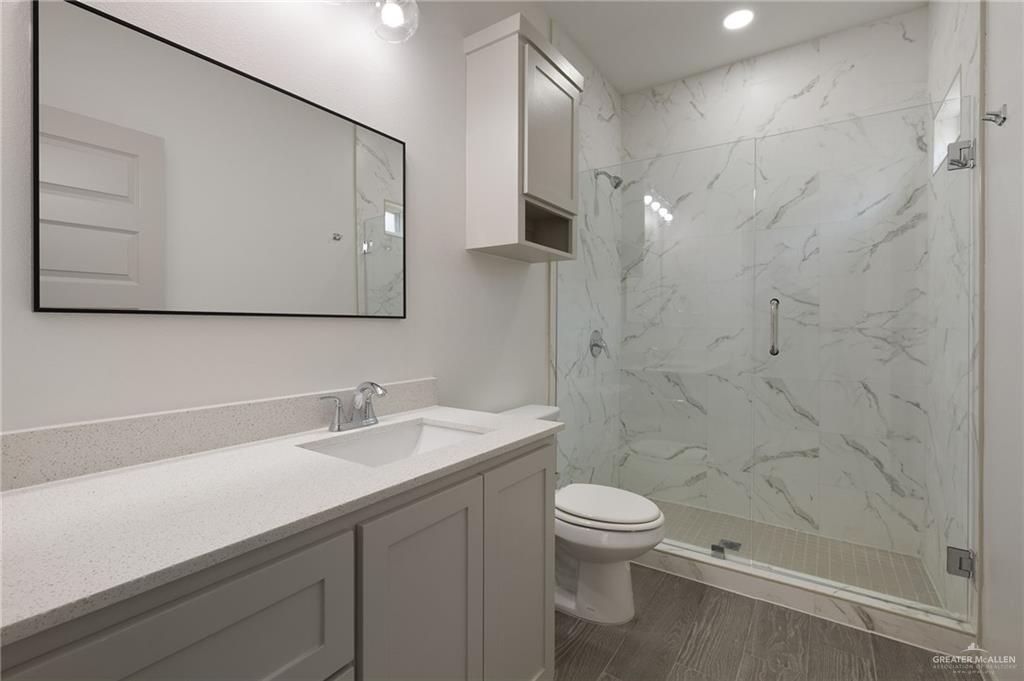 740 North Alamo Road, Unit 2 Alamo, TX 78516 - Photo 18 of 24 a bathroom with a sink a toilet and shower