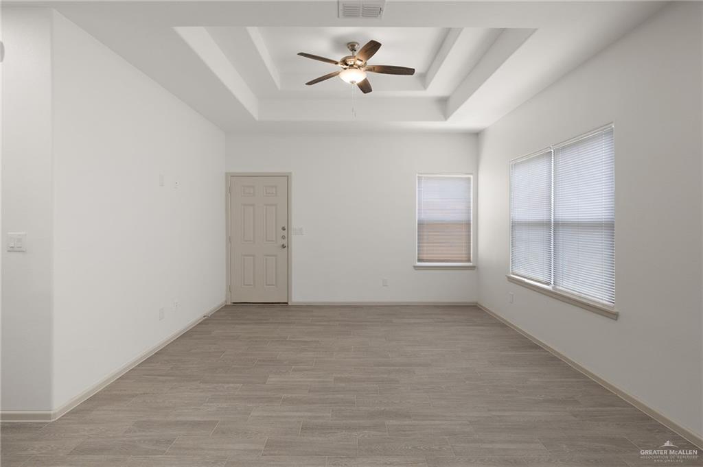 740 North Alamo Road, Unit 2 Alamo, TX 78516 - Photo 8 of 24 an empty room with fan and windows