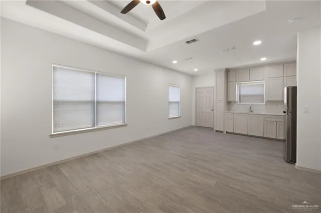 an empty room with closet and windows