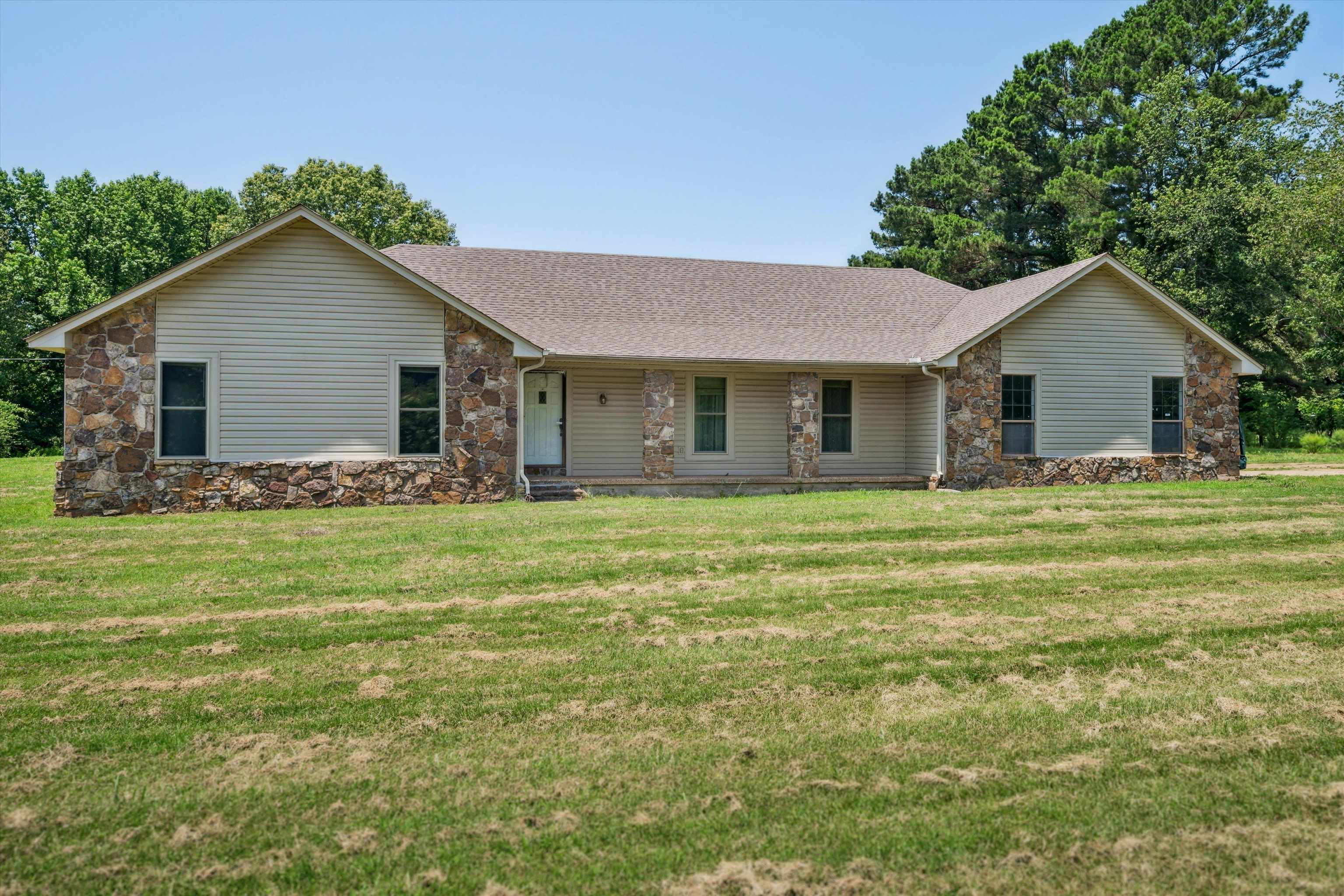 8783 Deadfall Road Millington, TN 38053 - Photo 20 of 27 Ranch-style house with stone siding, a front yard, and roof with shingles