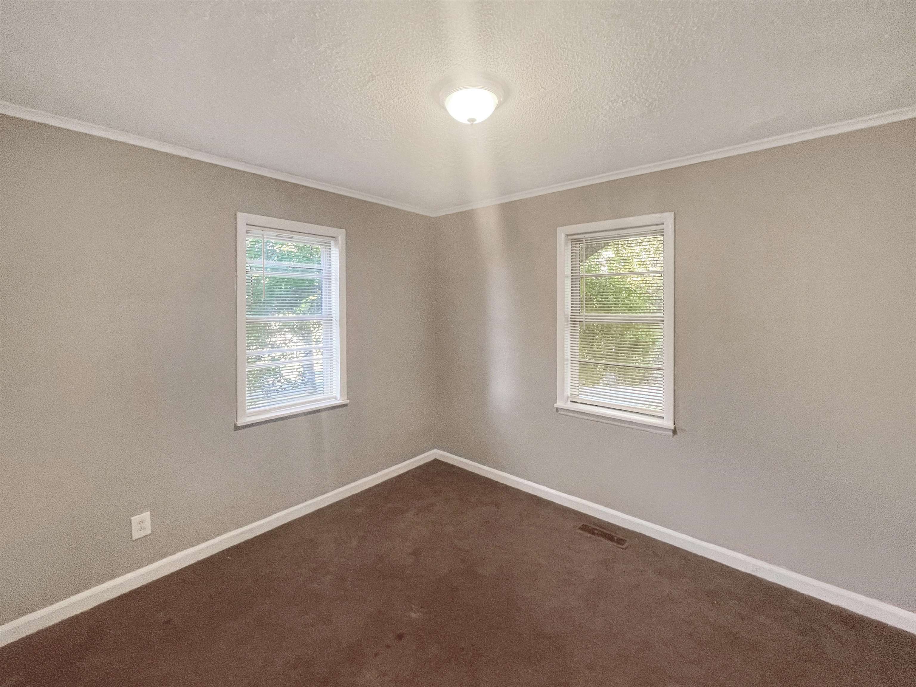 210 Tichenor Street Ripley, TN 38063 - Photo 6 of 10 an empty room with windows
