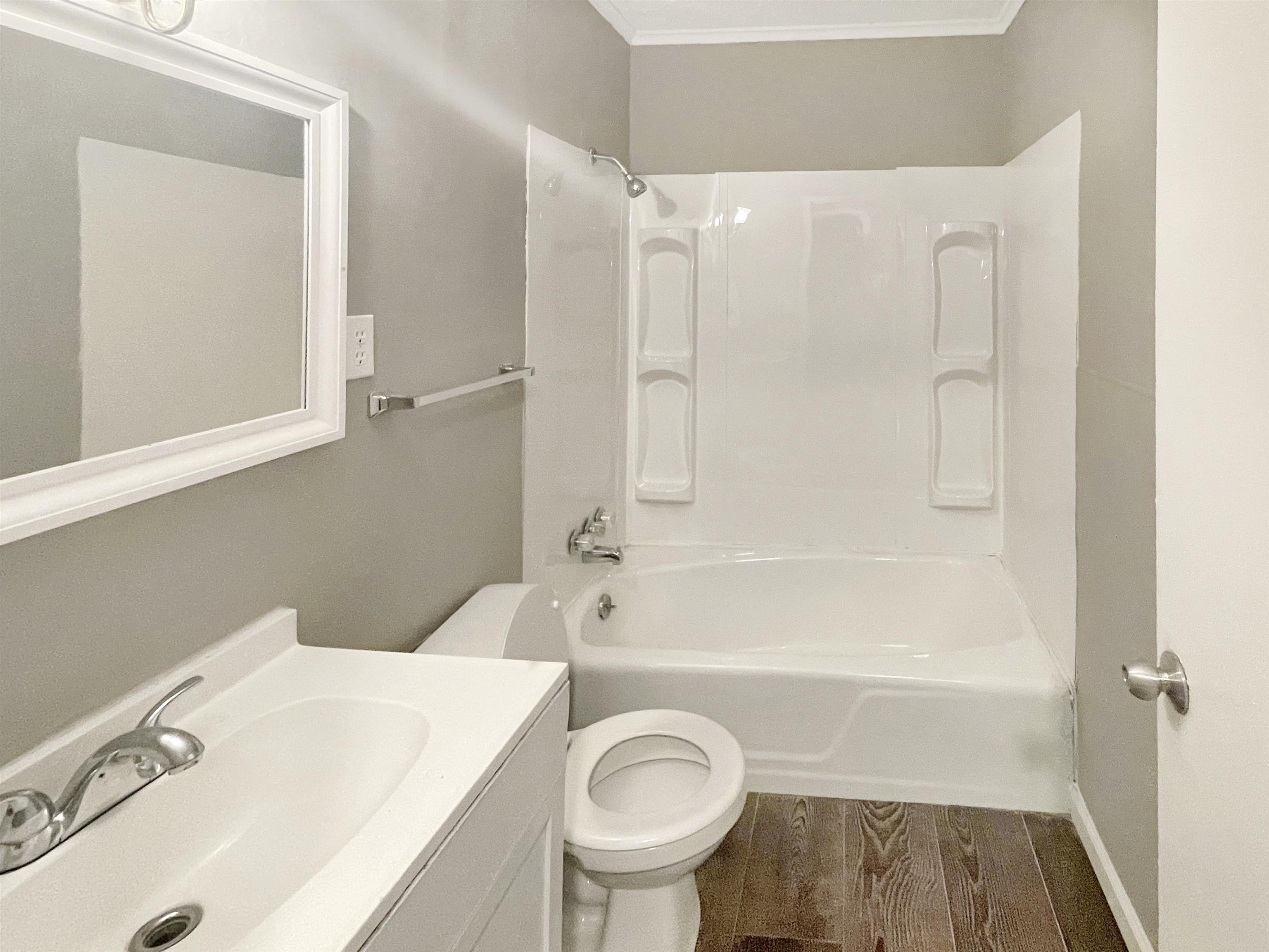 210 Tichenor Street Ripley, TN 38063 - Photo 7 of 10 a bathroom with a sink a toilet and a bathtub