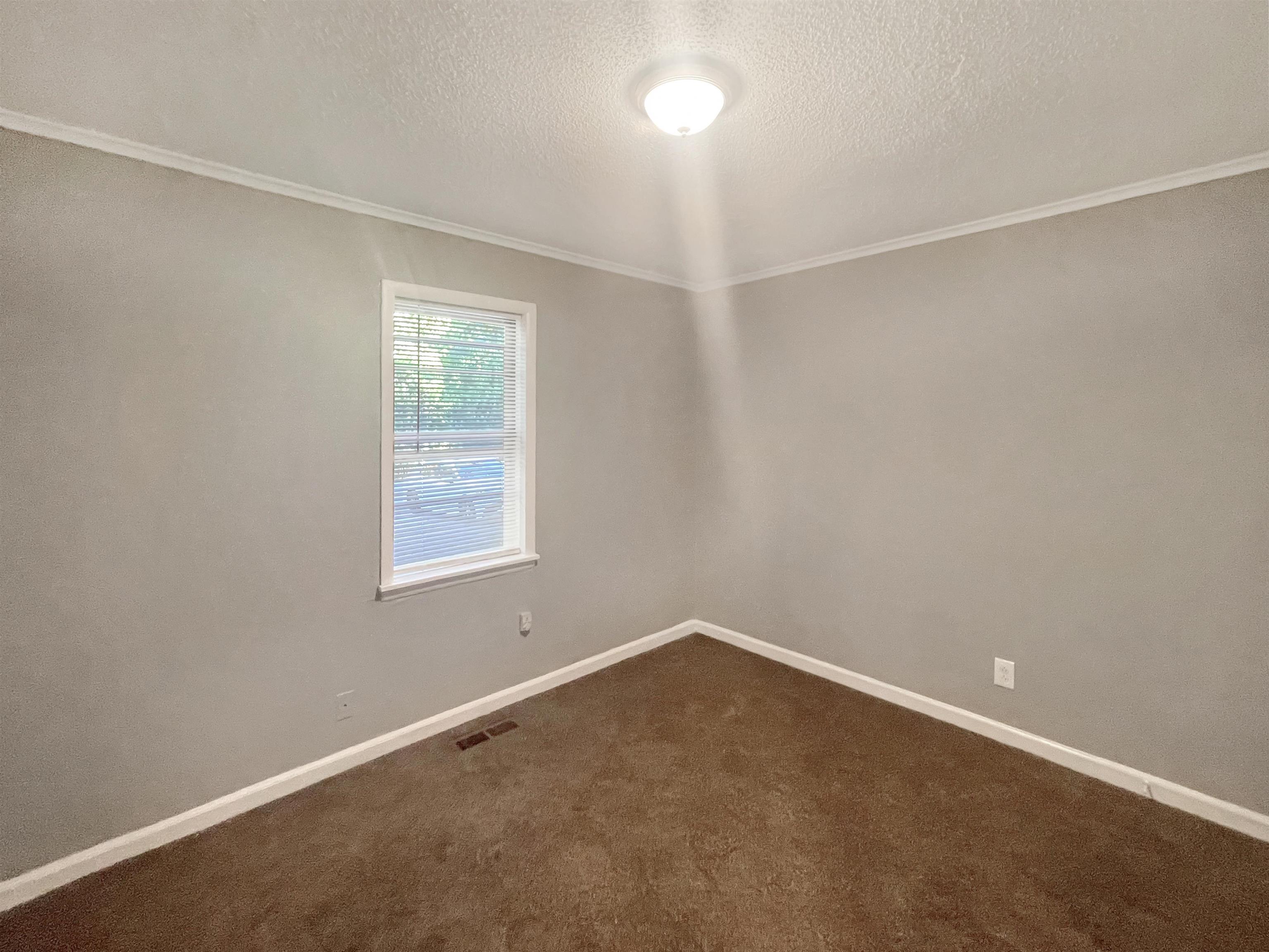 210 Tichenor Street Ripley, TN 38063 - Photo 8 of 10 an empty room with a window