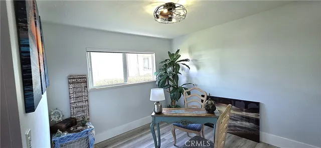 a view of entryway with furniture and wooden floor