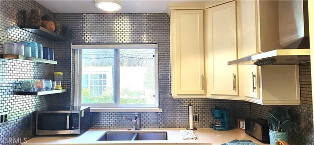 a bathroom with a sink a bathtub and next to a window