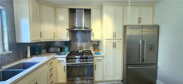a kitchen with a refrigerator and a sink