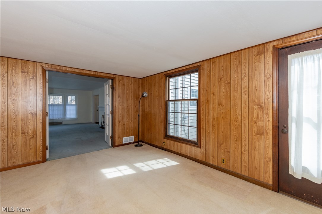 1050 Renfield Road Cleveland Heights, OH 44121 - Photo 16 of 41 Family room with light carpet and wood walls