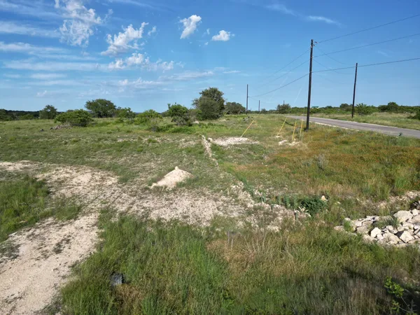a view of a golf course with an ocean