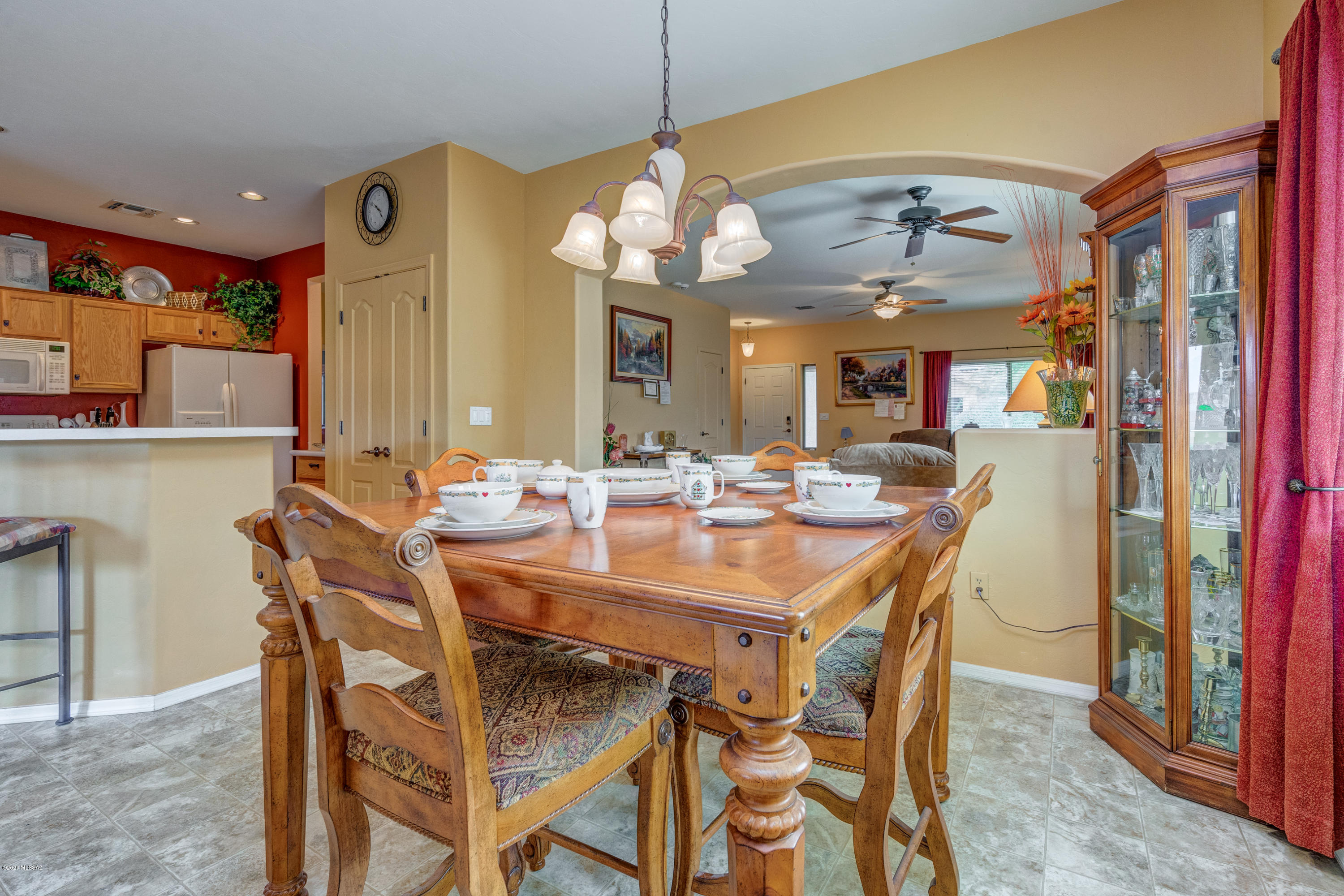 3640 East Northern Dancer Road Tucson, AZ 85739 - Photo 17 of 47 a view of a dining room with furniture and a chandelier