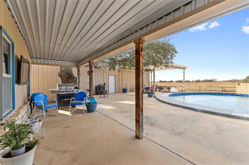6500 A Farm To Market 586 Bangs, TX 76823 - Photo 13 of 40 a view of a patio with table and chairs potted plants with floor to ceiling window