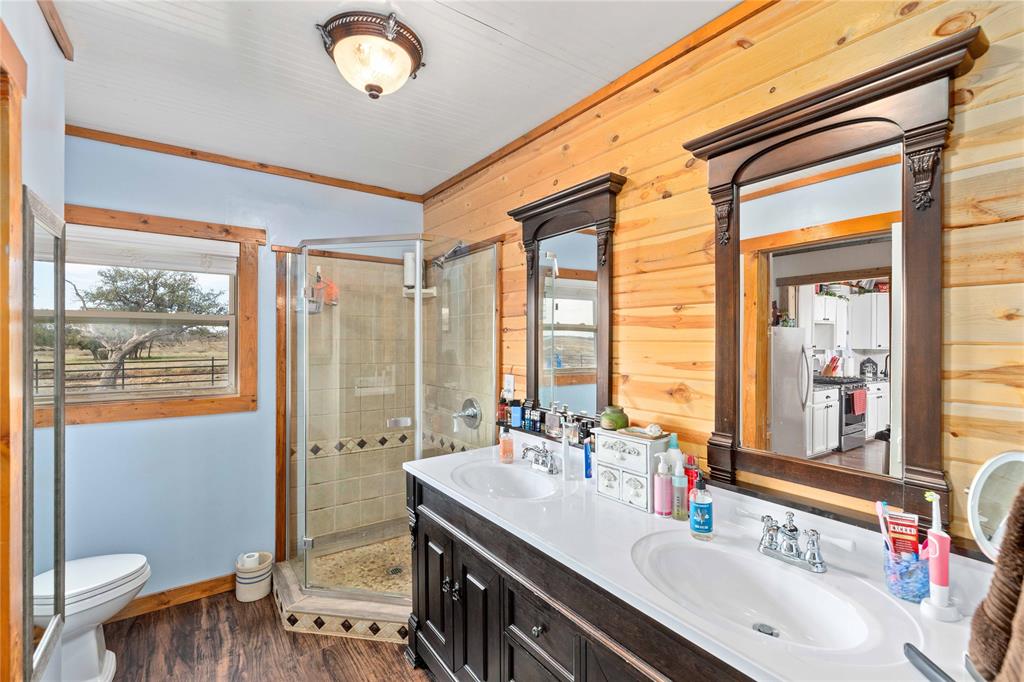 6500 A Farm To Market 586 Bangs, TX 76823 - Photo 9 of 40 a bathroom with a double vanity sink toilet and a tub