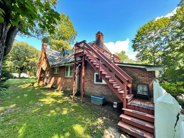 471 Bridge Road Northampton, MA 01062 - Photo 3 of 22 a view of a house with a small yard and a large tree