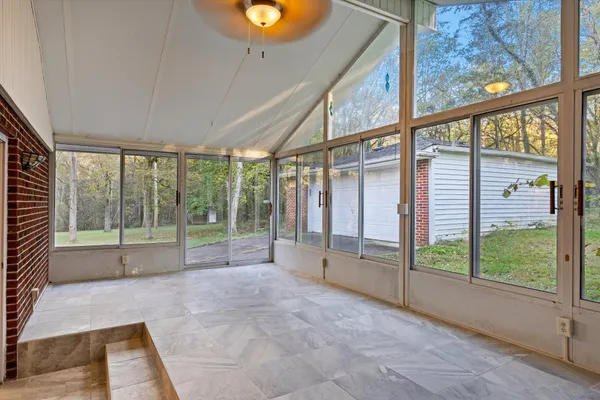 an empty room with floor to ceiling windows and city view