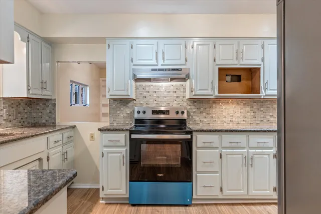 a view of a dining room with furniture and a potted plant