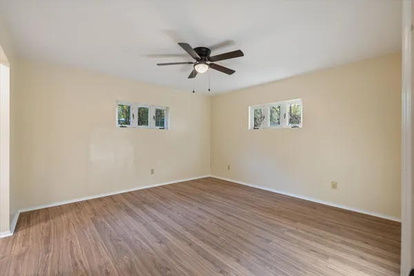 a view of an empty room and wooden floor