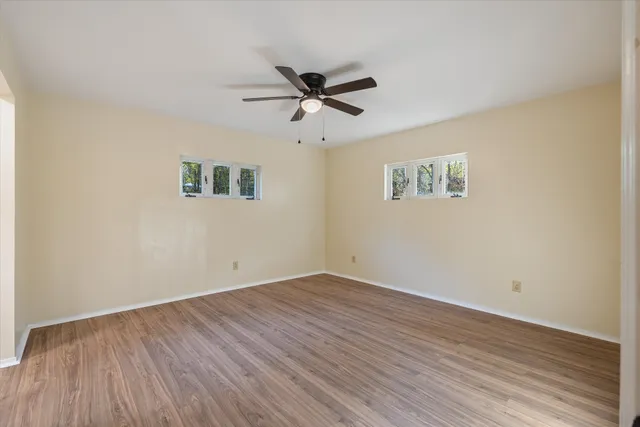a view of an empty room and wooden floor