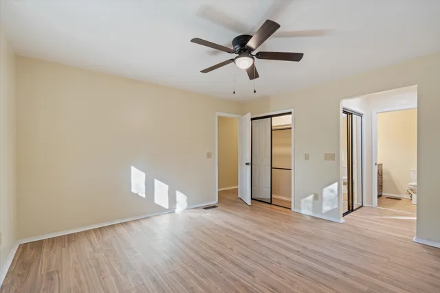 a bathroom with a granite countertop sink a toilet and shower