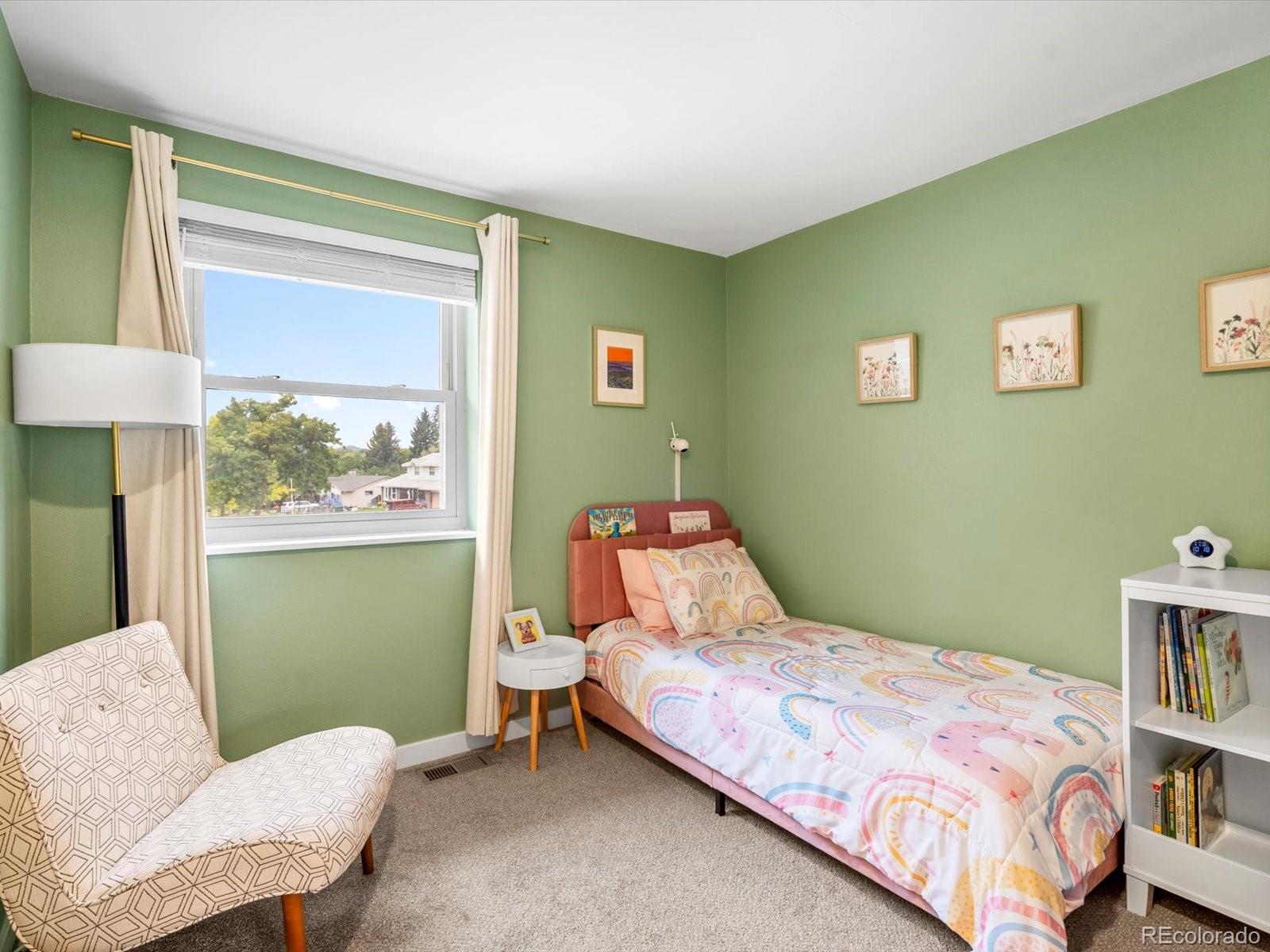 8324 Everett Way Arvada, CO 80005 - Photo 18 of 39 a bedroom with a bed and a window