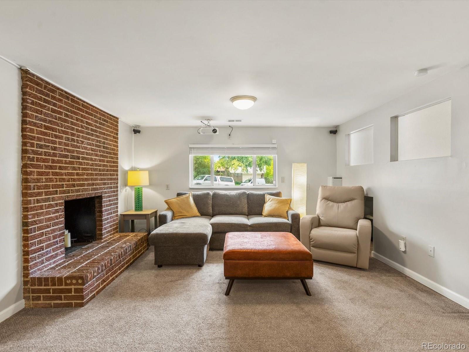 8324 Everett Way Arvada, CO 80005 - Photo 20 of 39 a living room with furniture and a fireplace