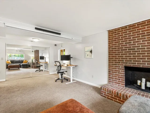 a view of a livingroom with furniture and a fireplace