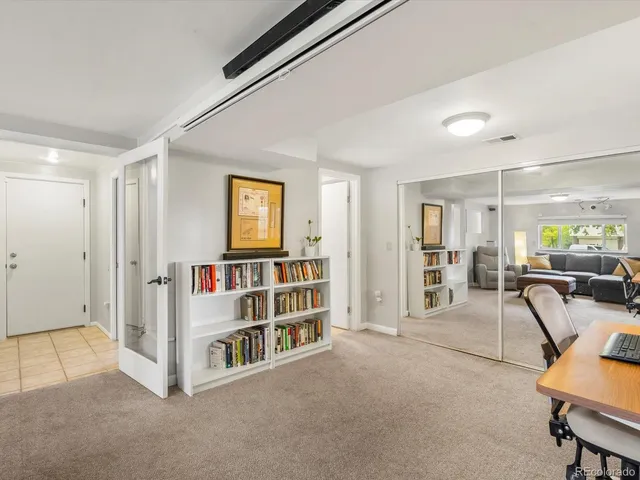 a view of a livingroom with furniture and a bookshelf