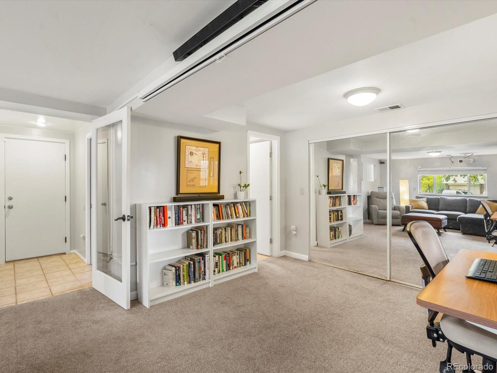 8324 Everett Way Arvada, CO 80005 - Photo 22 of 39 a view of a livingroom with furniture and a bookshelf