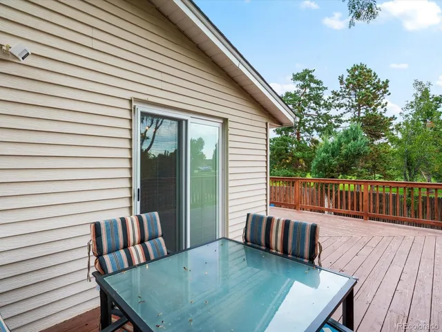 a view of a deck with a table and chairs with wooden floor