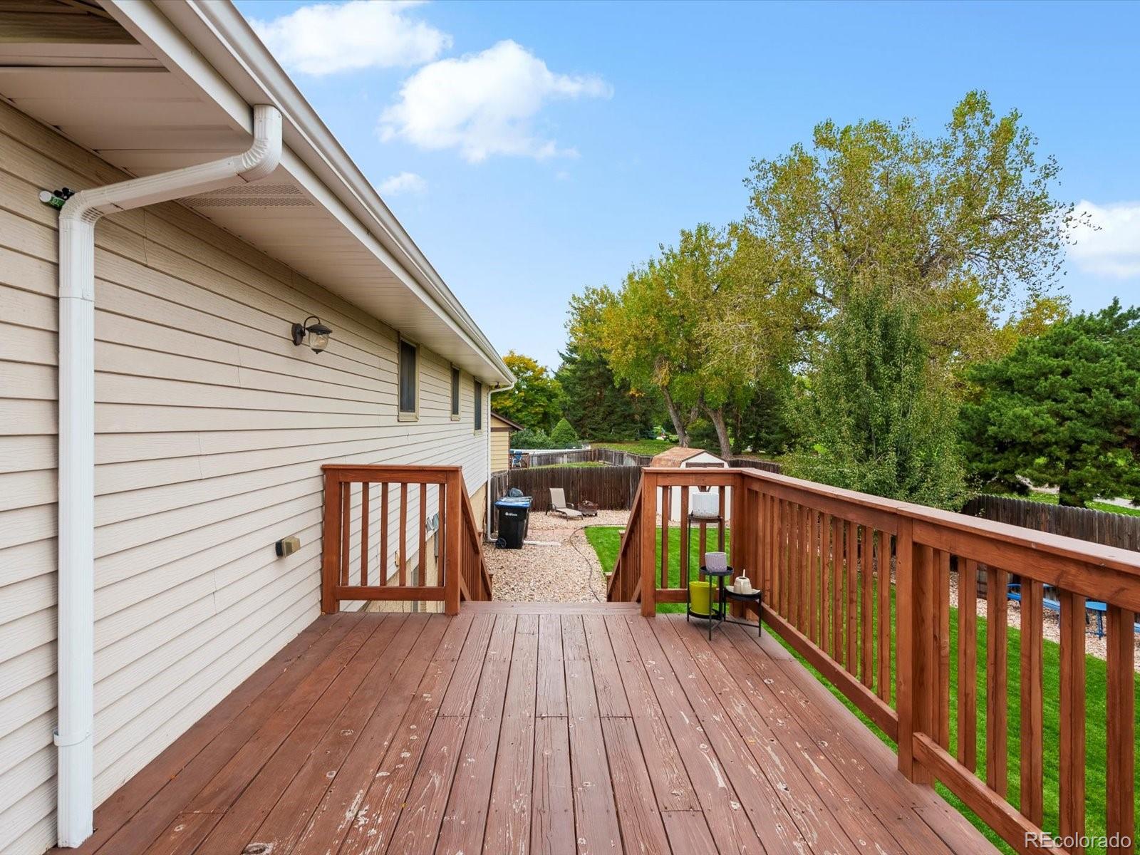 8324 Everett Way Arvada, CO 80005 - Photo 26 of 39 a view of balcony with deck and wooden floor