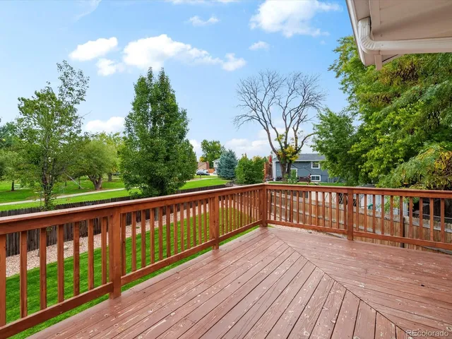 a view of roof deck with wooden floor and fence