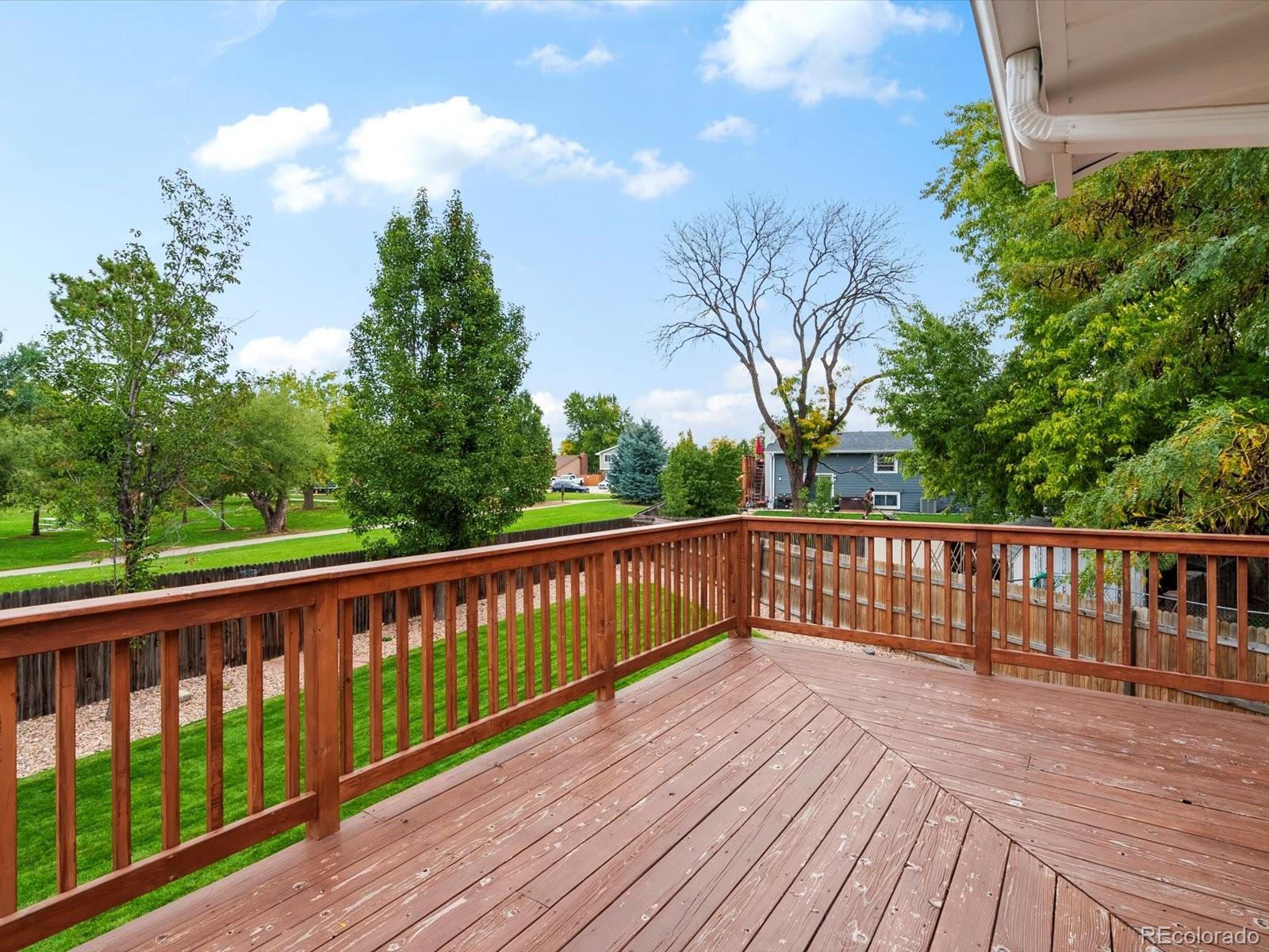 8324 Everett Way Arvada, CO 80005 - Photo 27 of 39 a view of roof deck with wooden floor and fence