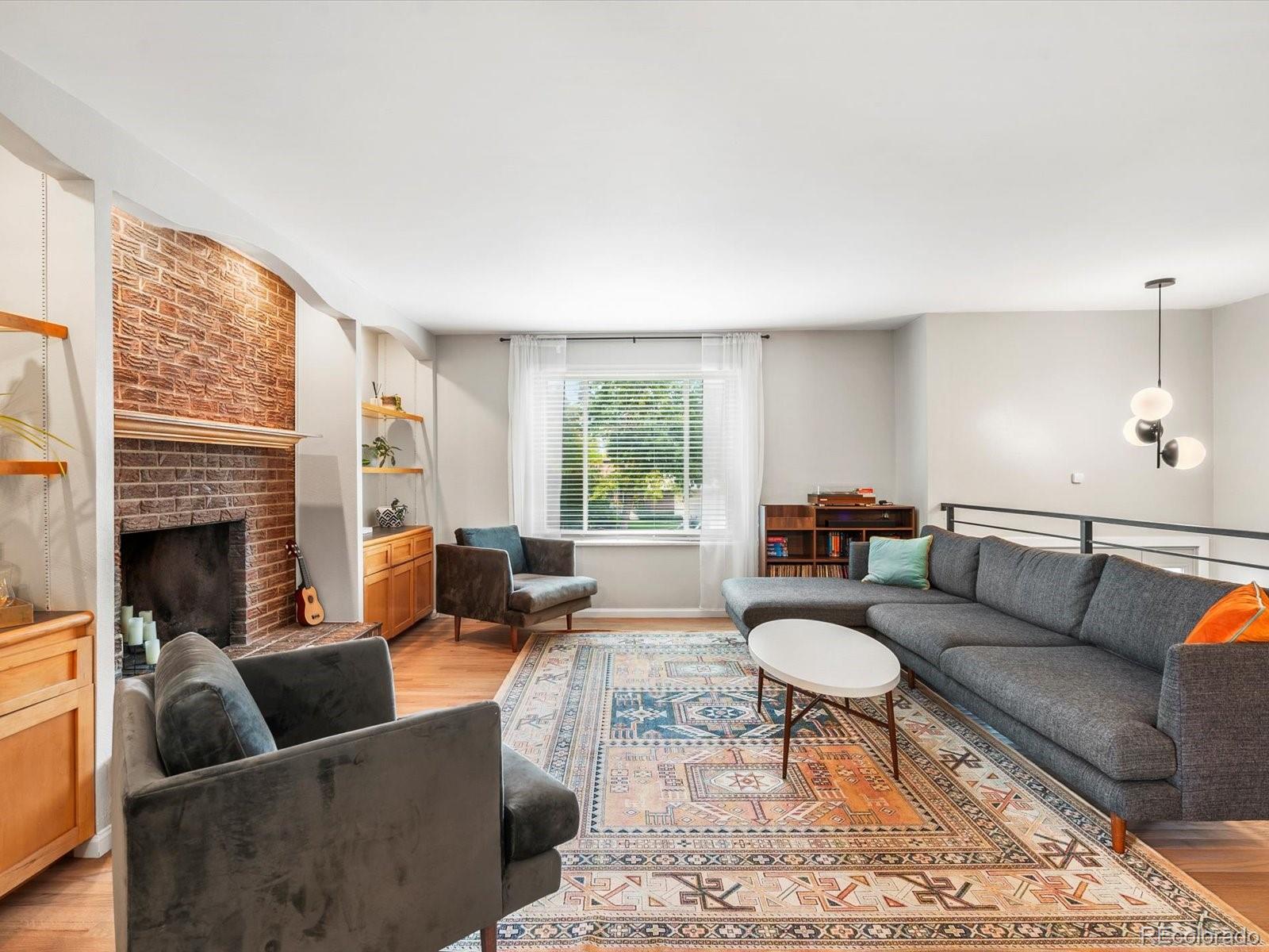 8324 Everett Way Arvada, CO 80005 - Photo 3 of 39 a living room with furniture and a fireplace