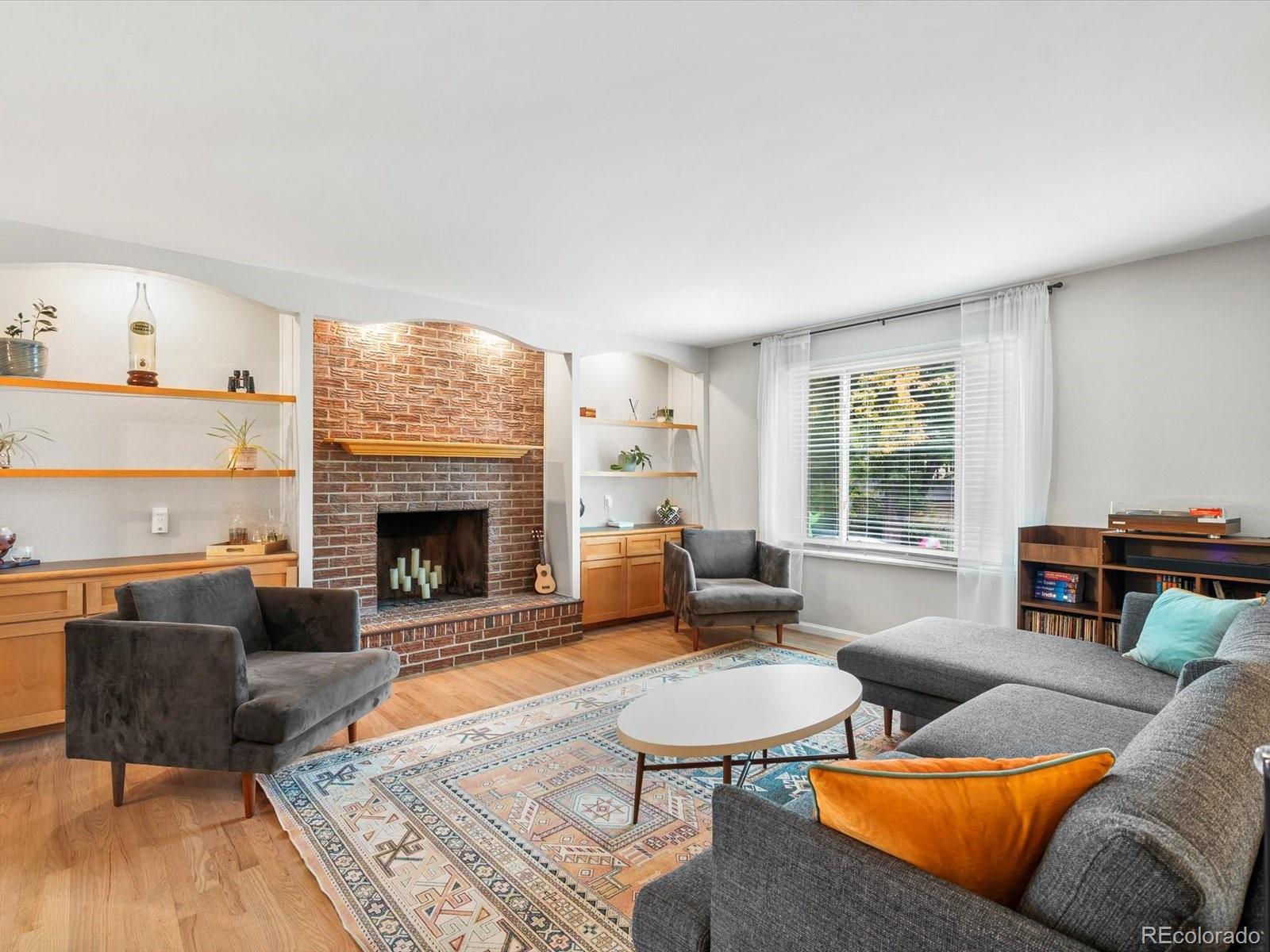 8324 Everett Way Arvada, CO 80005 - Photo 3 of 39 a living room with furniture and a fireplace