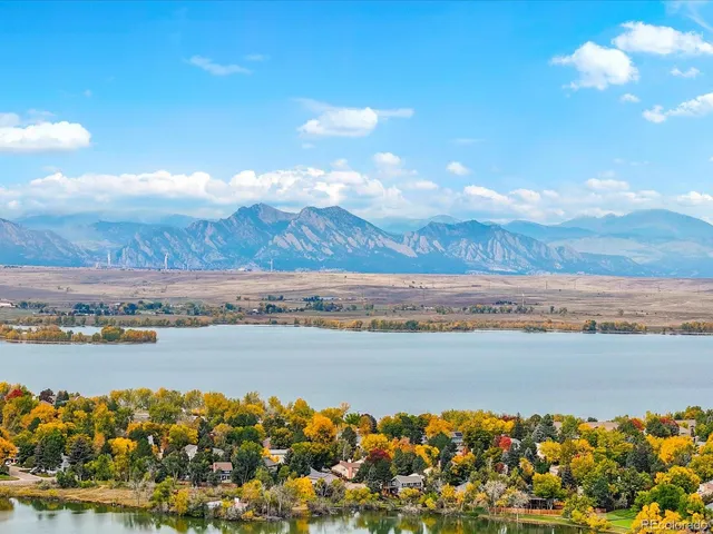 a view of a lake with houses in the back