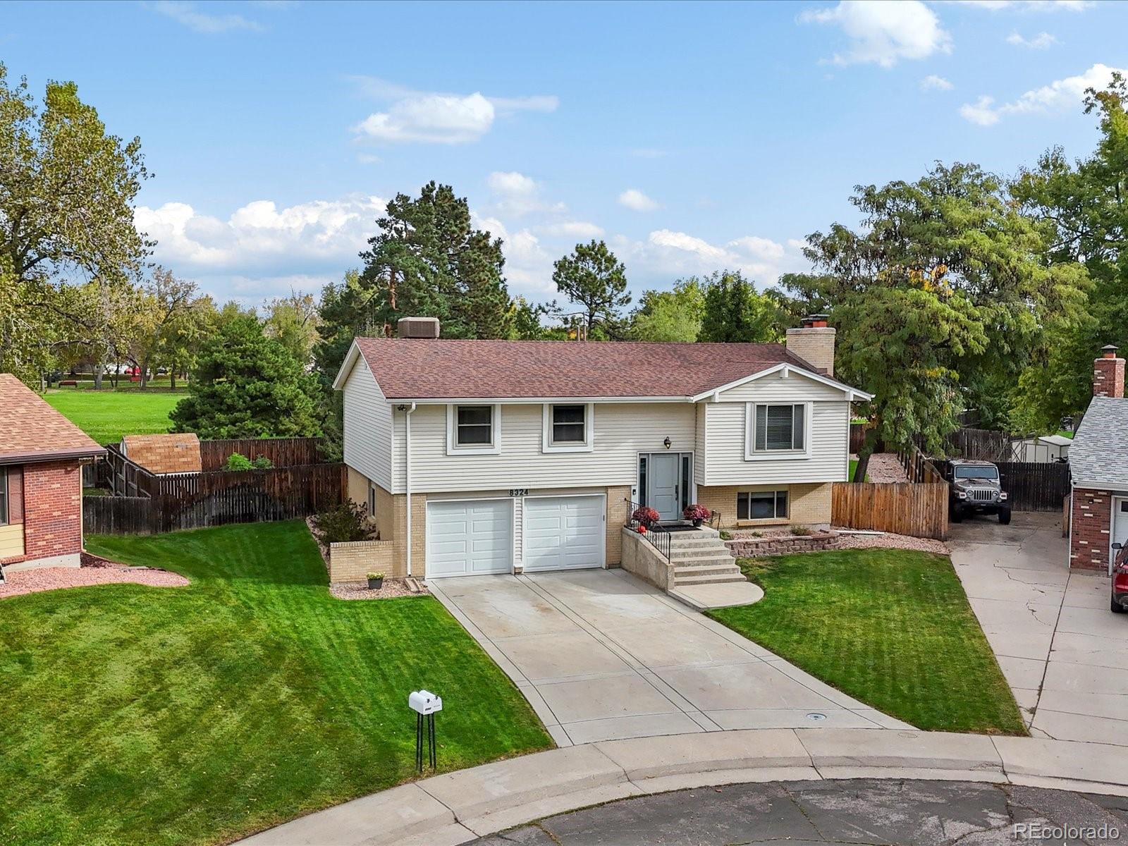 8324 Everett Way Arvada, CO 80005 - Photo 35 of 39 a front view of a house with a yard and trees