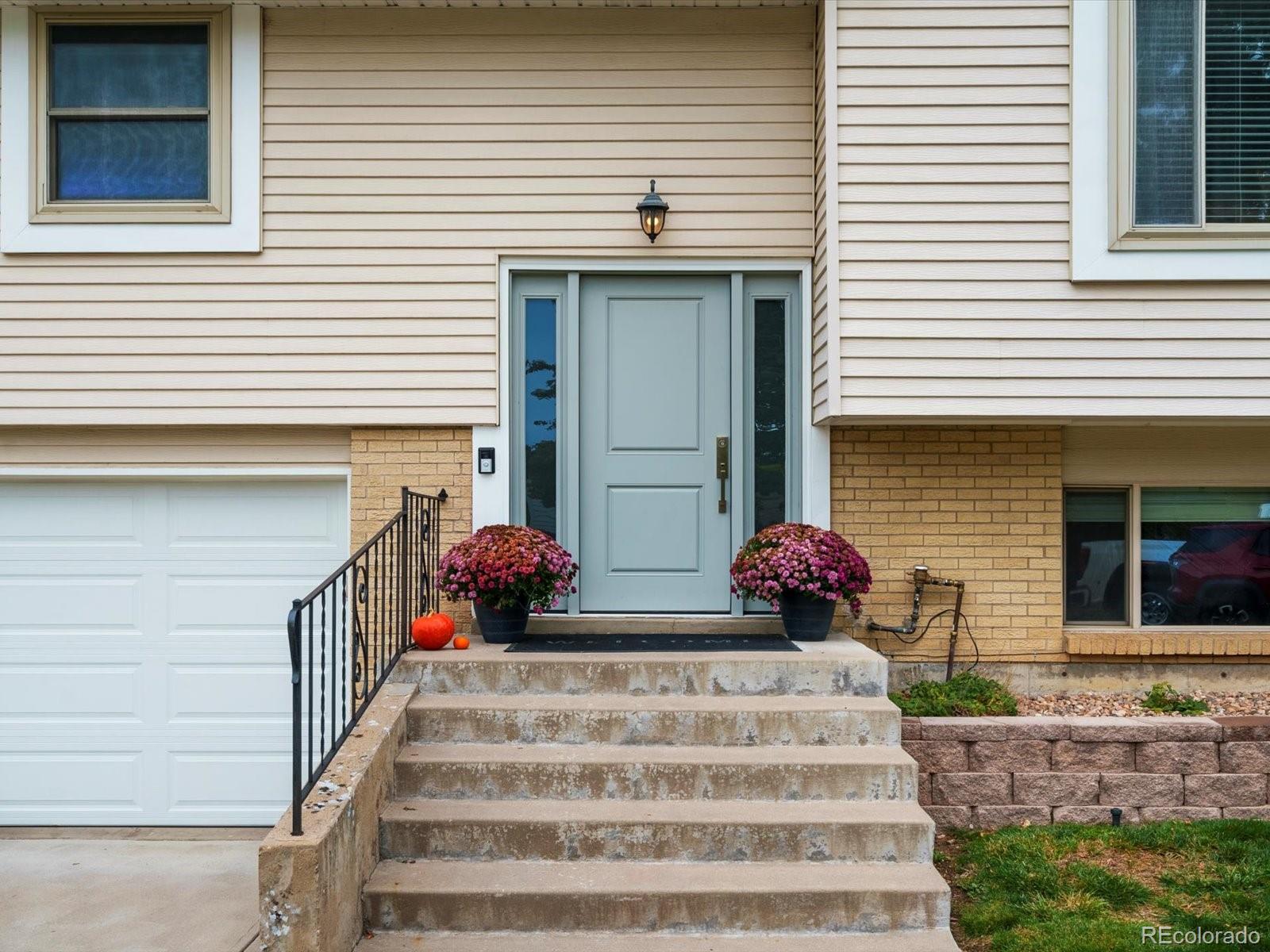 8324 Everett Way Arvada, CO 80005 - Photo 36 of 39 a front view of a house with large windows