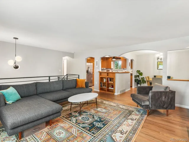 a living room with furniture and wooden floor