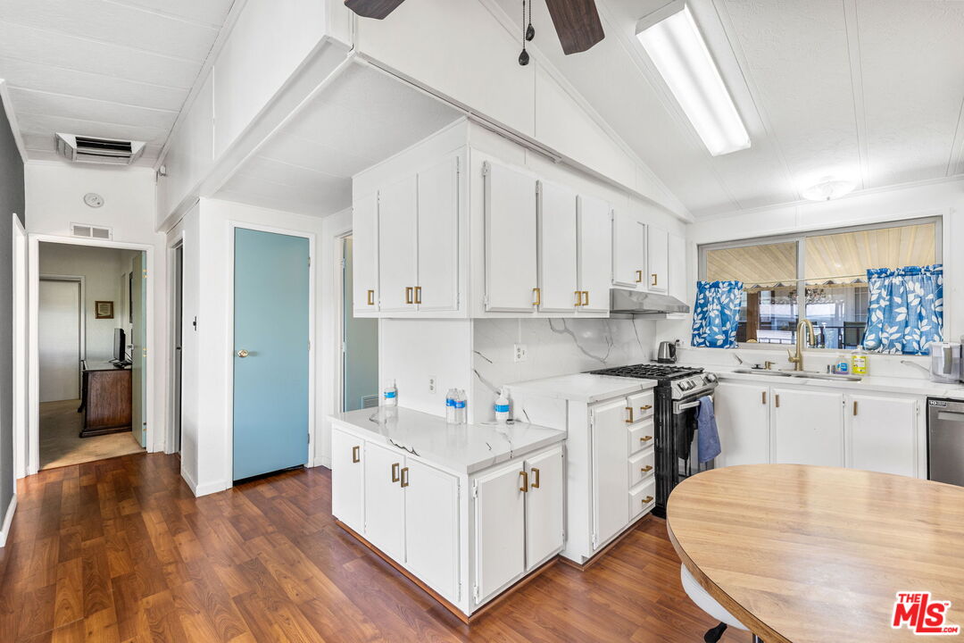 74711 Dillon Road, Unit 503 Desert Hot Springs, CA 92241 - Photo 13 of 52 a kitchen with white cabinets and white appliances