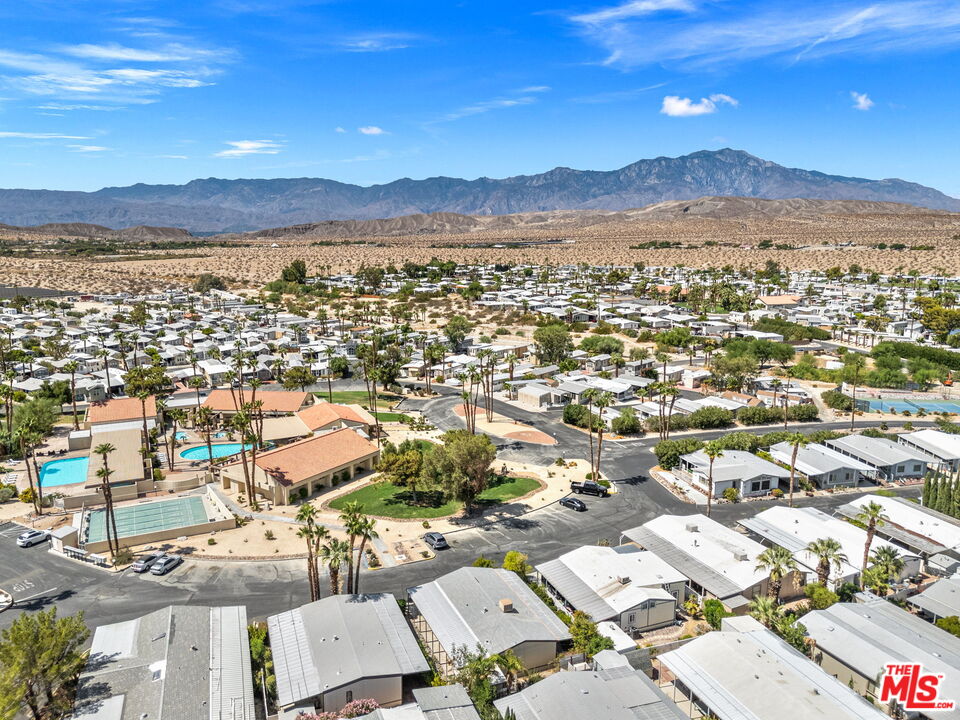 74711 Dillon Road, Unit 503 Desert Hot Springs, CA 92241 - Photo 18 of 52 an aerial view of a city with lots of residential buildings and mountain view in back