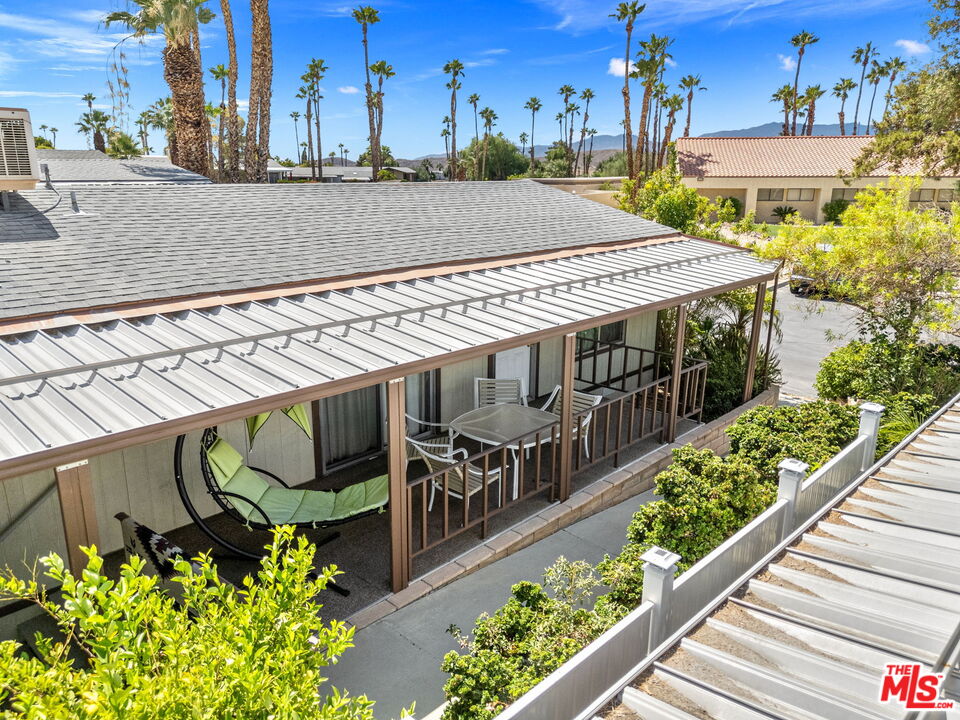 74711 Dillon Road, Unit 503 Desert Hot Springs, CA 92241 - Photo 19 of 52 a view of a wooden house with large windows