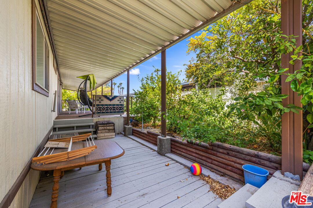 74711 Dillon Road, Unit 503 Desert Hot Springs, CA 92241 - Photo 22 of 52 a wooden bench sitting in front of a building