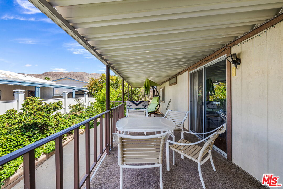 74711 Dillon Road, Unit 503 Desert Hot Springs, CA 92241 - Photo 25 of 52 a view of a patio with table and chairs