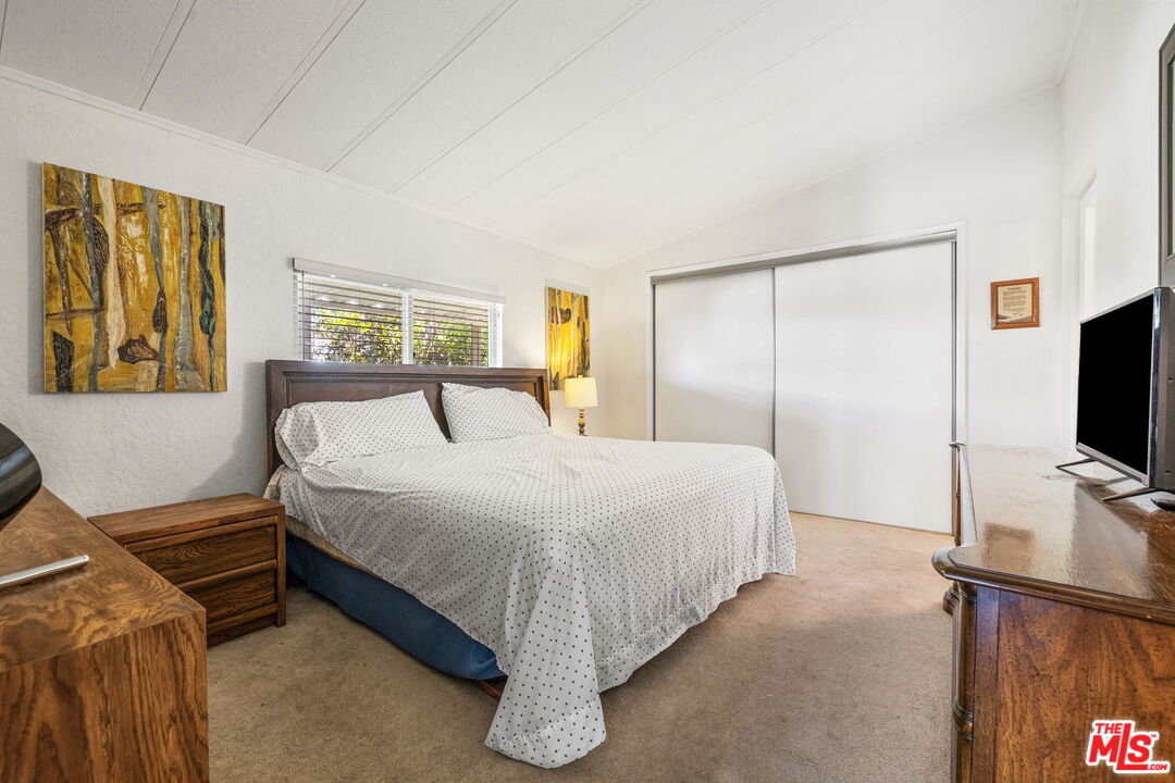 74711 Dillon Road, Unit 503 Desert Hot Springs, CA 92241 - Photo 31 of 52 a bedroom with a bed and a flat screen television