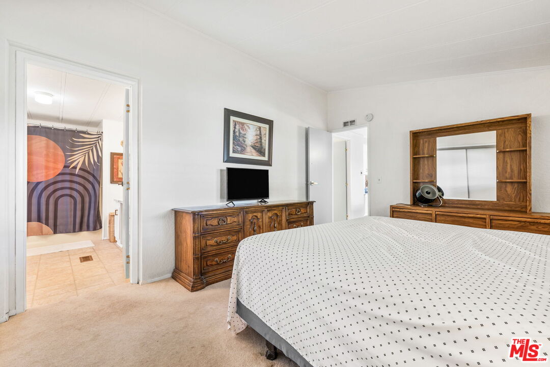 74711 Dillon Road, Unit 503 Desert Hot Springs, CA 92241 - Photo 32 of 52 a bedroom with a bed and a couch