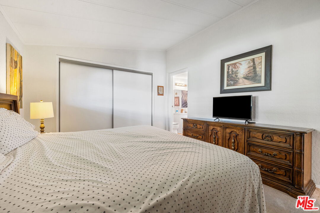 74711 Dillon Road, Unit 503 Desert Hot Springs, CA 92241 - Photo 33 of 52 a bedroom with a bed and a flat screen tv