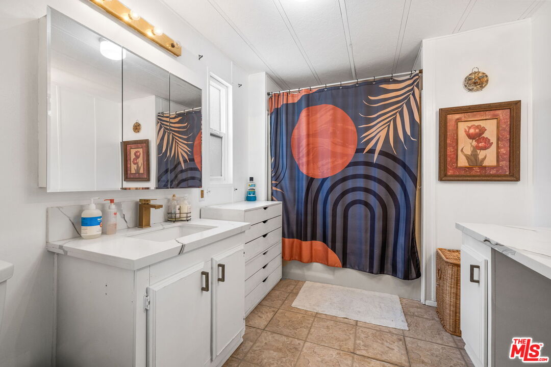 74711 Dillon Road, Unit 503 Desert Hot Springs, CA 92241 - Photo 34 of 52 a bathroom with a sink a mirror a lamp and bathtub