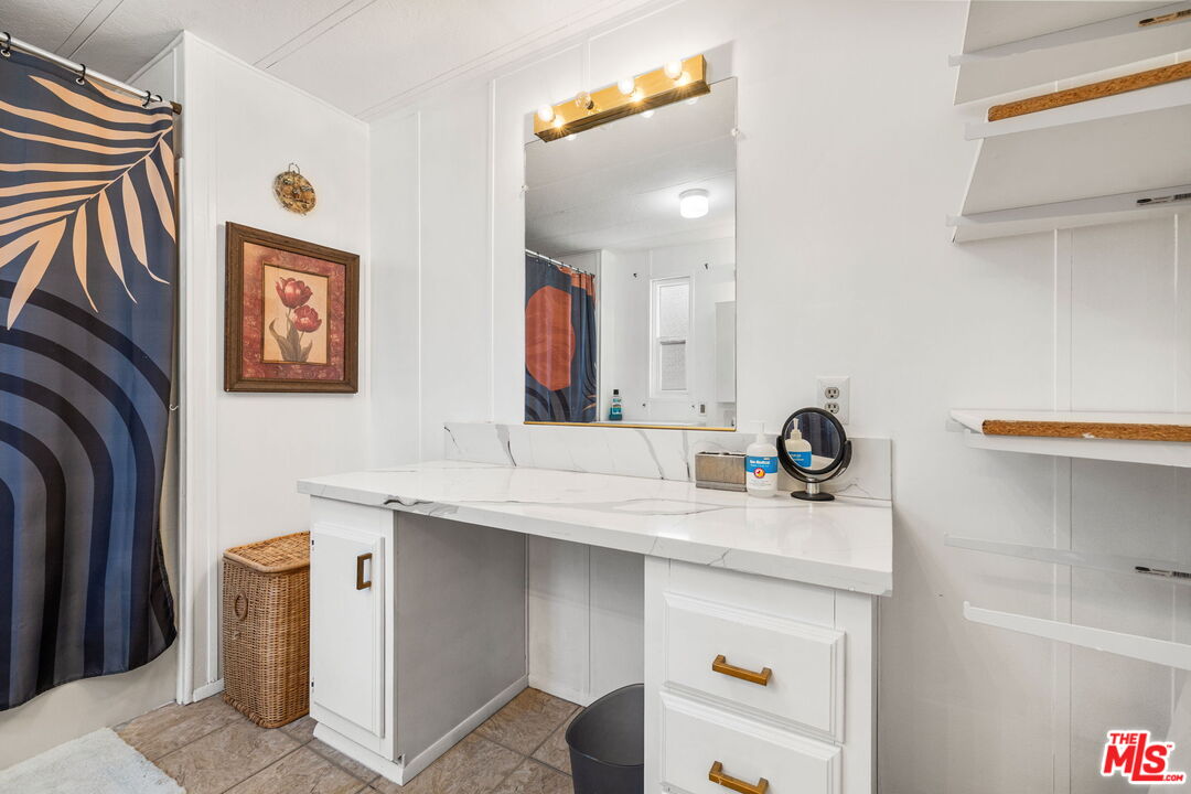 74711 Dillon Road, Unit 503 Desert Hot Springs, CA 92241 - Photo 35 of 52 a bathroom with a sink a mirror and a shower