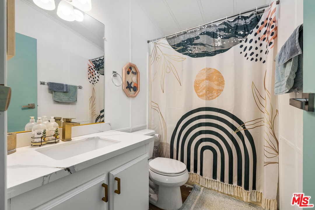 74711 Dillon Road, Unit 503 Desert Hot Springs, CA 92241 - Photo 36 of 52 a bathroom with a sink a washer and dryer