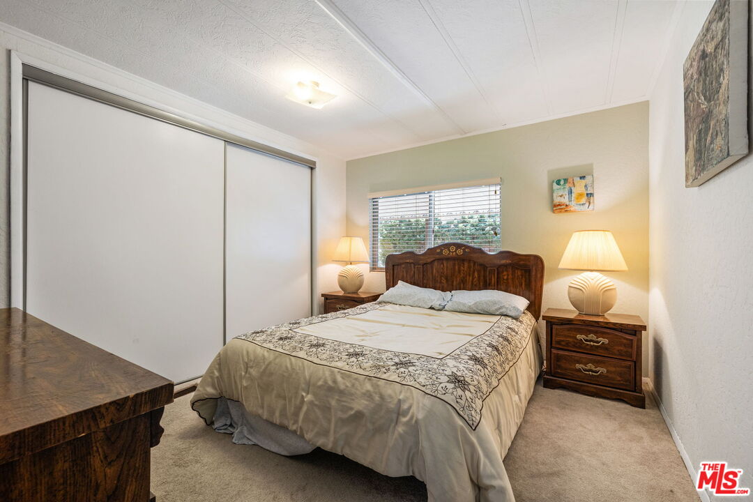 74711 Dillon Road, Unit 503 Desert Hot Springs, CA 92241 - Photo 37 of 52 a bedroom with a bed and a night stand